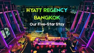 Panoramic evening skyline view from the rooftop bar at Hyatt Regency Bangkok Sukhumvit luxury hotel in Thailand.