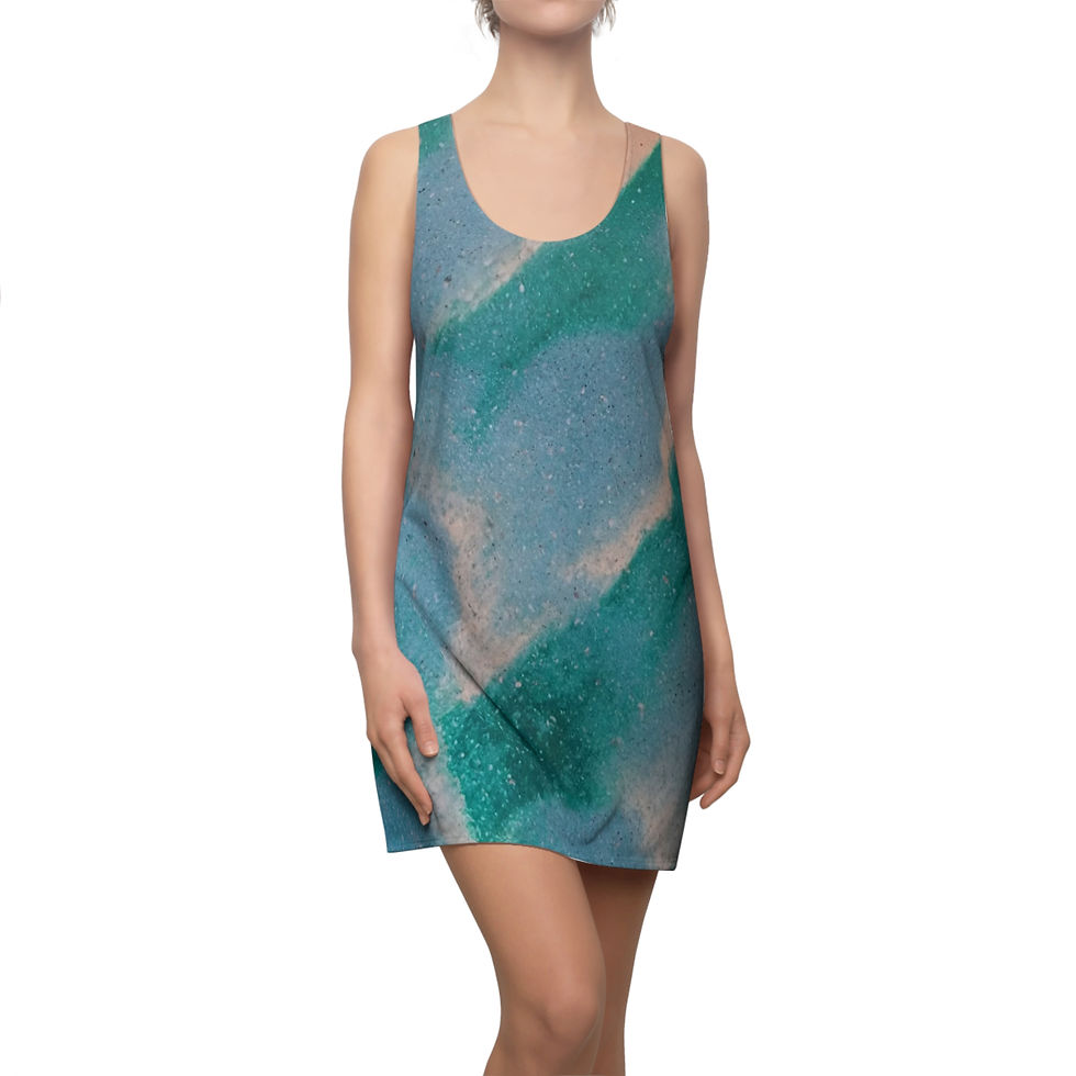 A person wearing a sleeveless dress with a teal and beige abstract pattern stands against a plain background.