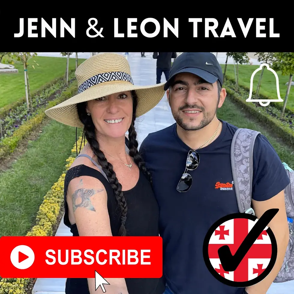 A smiling couple poses in a garden path. Woman in a sunhat with a tattoo. Text: "JENN & LEON TRAVEL." Subscribe button is visible.