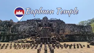 Ancient stone temple ruins under a clear blue sky, with "Baphuon Temple" text and flag emblem above. Stone columns in the foreground.