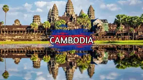 Angkor Wat temple complex reflected in water with palm trees and stone towers in Siem Reap.