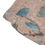 Thumbnail: Close-up a swim trunk pocket with various-sized blue and gray stone fragments embedded in a light pink terrazzo pattern.