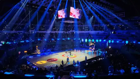 FIBA World Cup basketball game inside Smart Araneta Coliseum with illuminated court, crowd, and overhead screens.