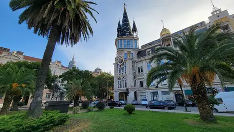 Astronomical clock on ornate building facade in Batumi city center.