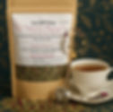 Kraft pouch with tea beside it