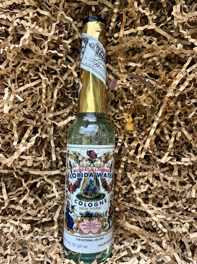Three spiritual cologne bottles arranged in a basket for ritual use