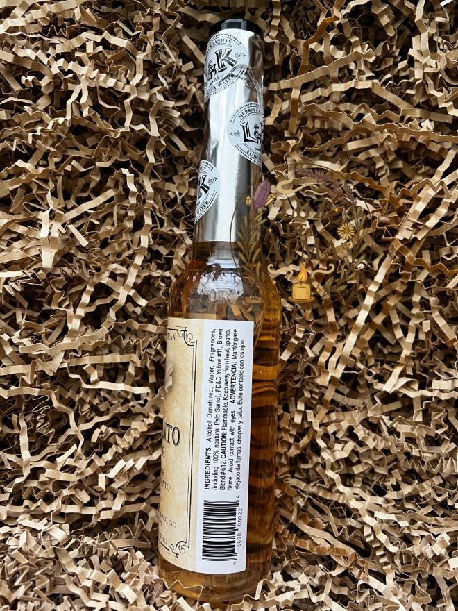 Thumbnail: Three 7.5 oz Palo Santo cologne bottles lying in a brown wicker basket with kraft crinkle paper