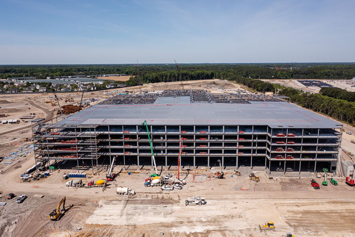 Drone overhead of steel-frame jobsite during construction in Norfolk VA.