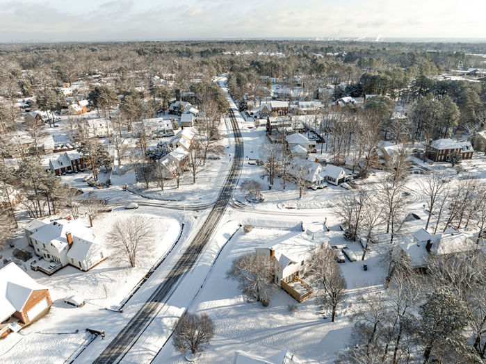 Drone overhead of Richmond neighborhood blanketed in snow.
