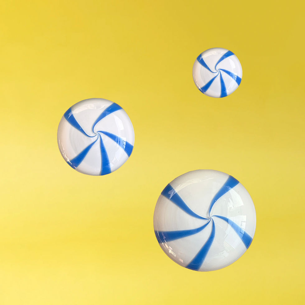 Three coatCANDY glass wall hooks by STUDIO BERG in small, medium and large, with swirling candy patterns