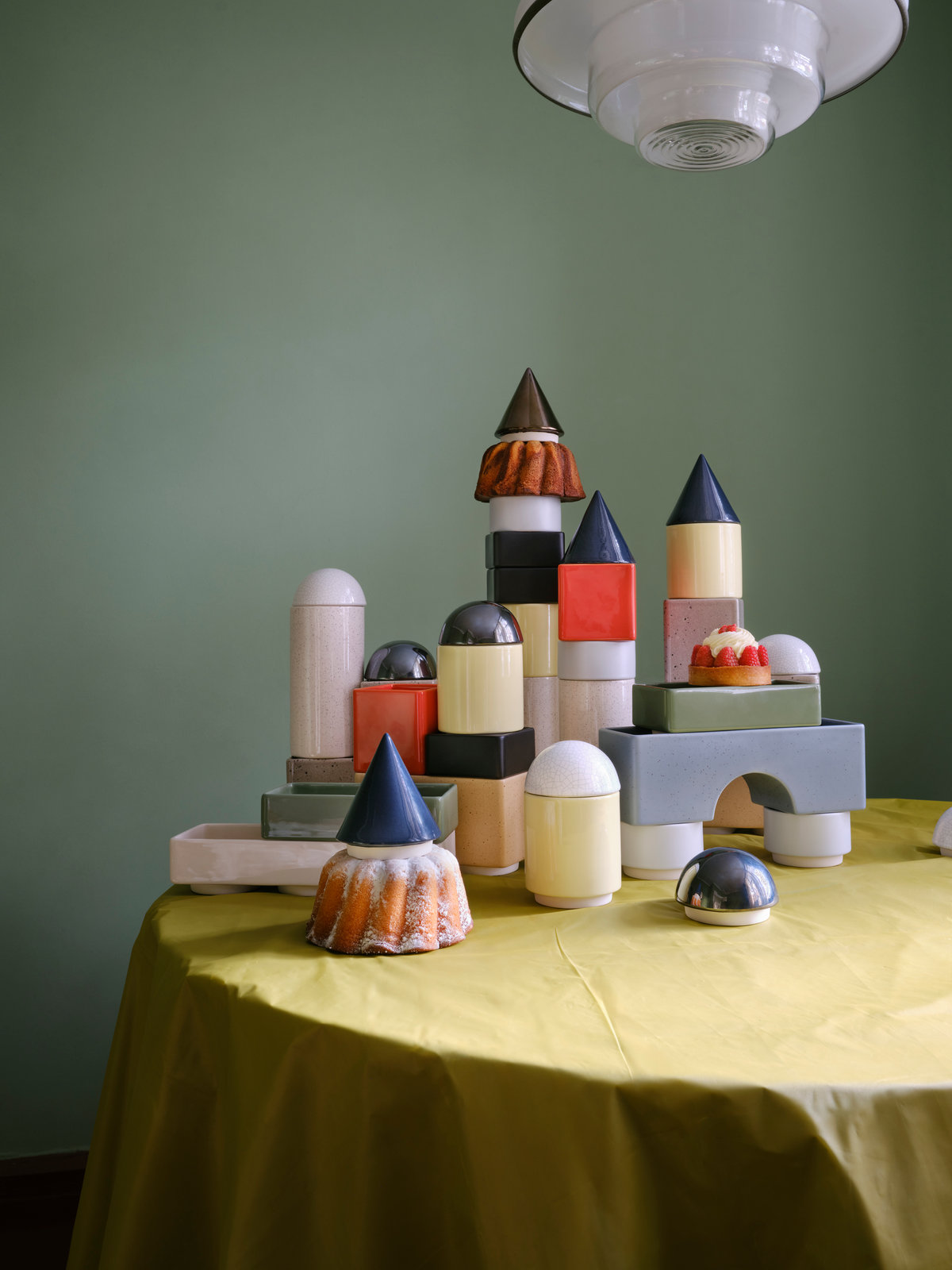 KNSTRKT ceramic castle by STUDIO BERG on a yellow tablecloth in the green room at Tautes Heim