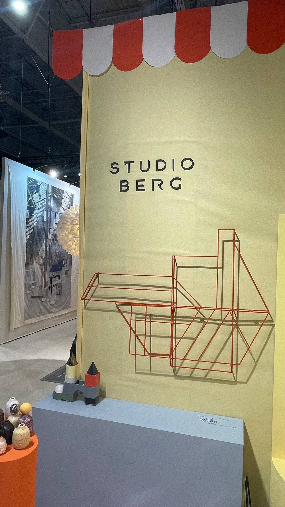 Red FOLDWORK clothing rack and KNSTRKT under the STUDIO BERG awning at Maison&Objet Paris