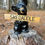 Thumbnail: black bear cub holding reversible skedaddle sign