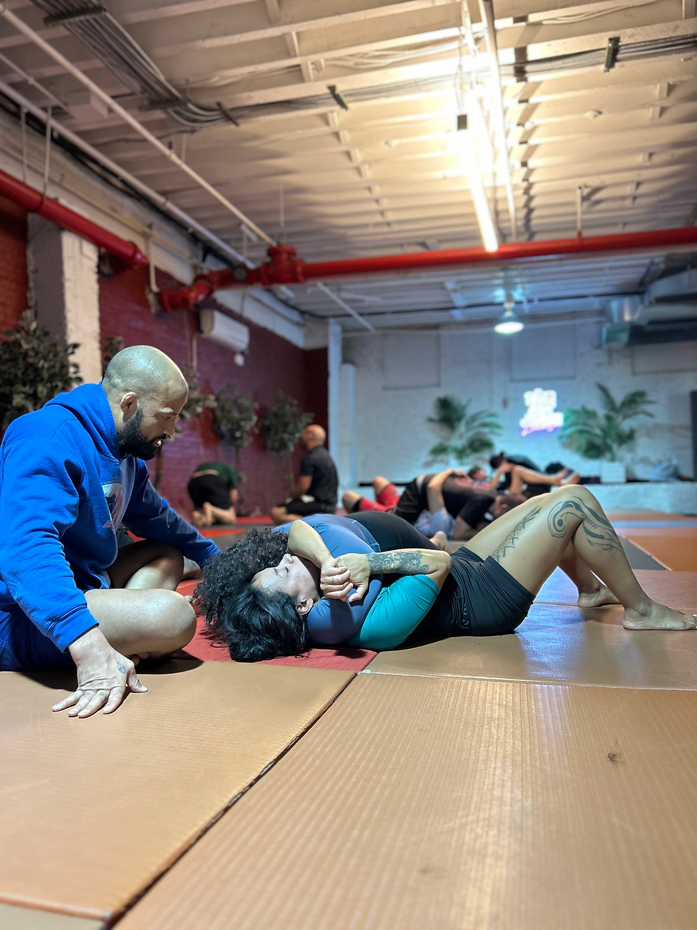 Coach Luis showing beginners how to do the head and arm choke