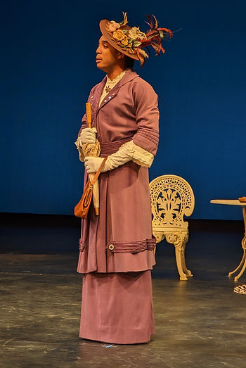 Late 19th century costumed woman in a mauve suit