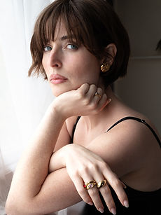 Valentina - headshot of a female model with short textured hair, a wide smile, with her hand placed on her chin, represented by ROC Talent Agency UK