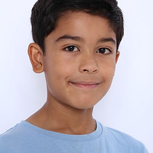 Tristan - a headshot of a junior model with short hair, a natural smile, and wearing a blue t-shirt, represented by ROC Talent Agency UK