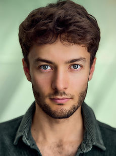 Andre - headshot of a male actor with textured hair, light stubble, and wearing a grey jumper, represented by ROC Talent Agency UK