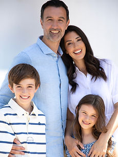 The Lee Family - a family modelling shot with two parents with bright smiles surrounded by their two children, their daughter with long dark hair and their son with a wide smile, all together, represented by ROC Talent Agency UK