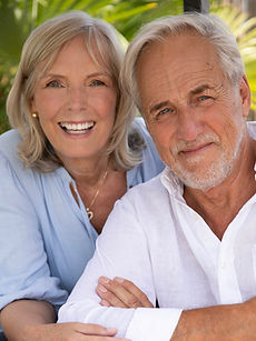 Kay and Keith - shot of a couple featuring a woman with curly hair, a wide smile, leaning on a man with a wide smile, and swept back hair, represented by ROC Talent Agency UK