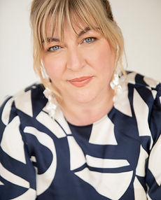 Nicola - A headshot of a real female model with shoulder length hair, a wide smile and wearing a patterned top represented by ROC Talent Agency UK