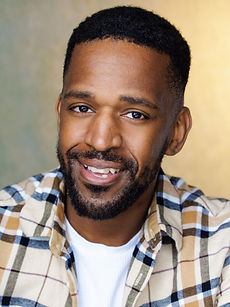 Brian B - A headshot of a real model with short dark hair, light stubble, and a bright smile, represented by Roc Talent Agency UK