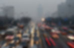 (Traffic runs amid heavy smog in Beijing on December 29. The government hopes to improve environmental conditions by promoting a shift to clean energy vehicles. Photo: Xinhua