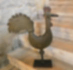 Antique Tin Rooster Weathervane sits on the stairs, showing craftsmanship and detail.