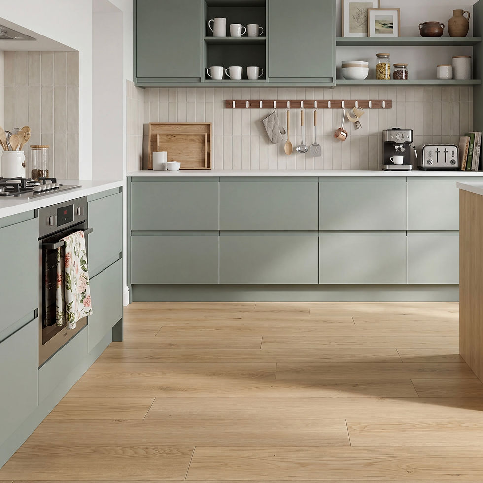 Modern sage-green kitchen with wood floor, open shelves, hanging utensils, coffee machine, toaster, and floral towel on oven.