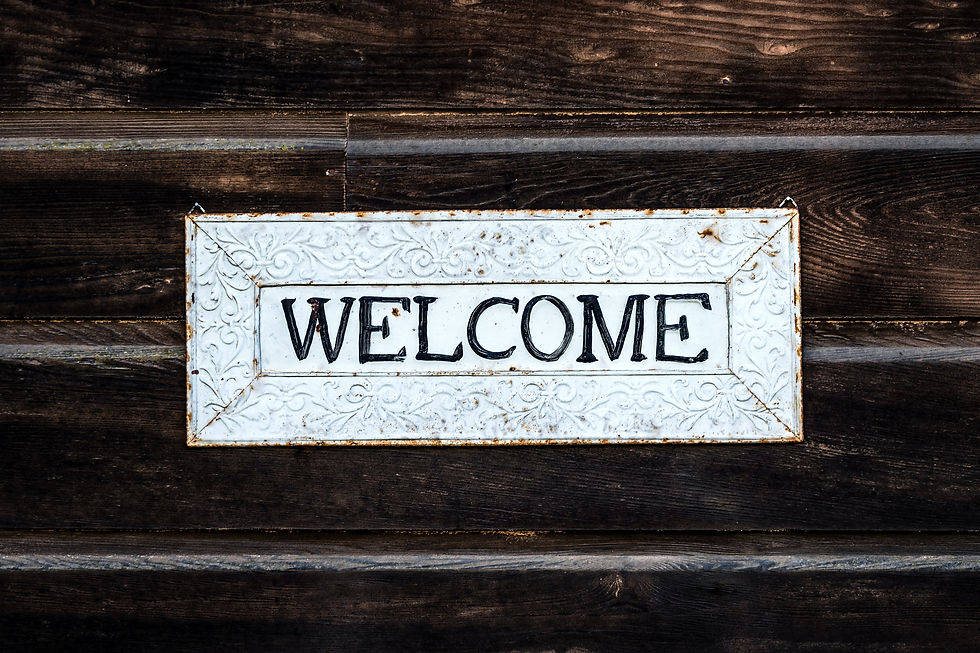 White welcome sign on wooden door, welcoming guests inside the house
