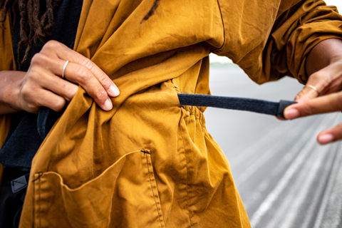 a close up of a person wearing a yellow jacket