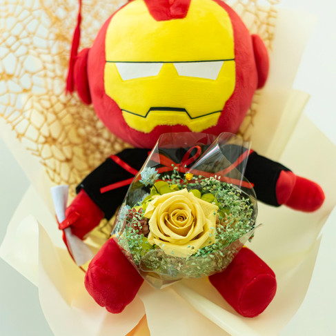 SKfleur Iron Man Marvel graduation plush bouquet in Singapore featuring a superhero soft toy holding an everlasting yellow preserved rose wrapped elegantly in golden-patterned mesh.
