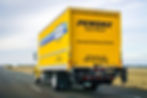 Penske box truck driving down the road