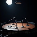 microphones on a round table in a dimly