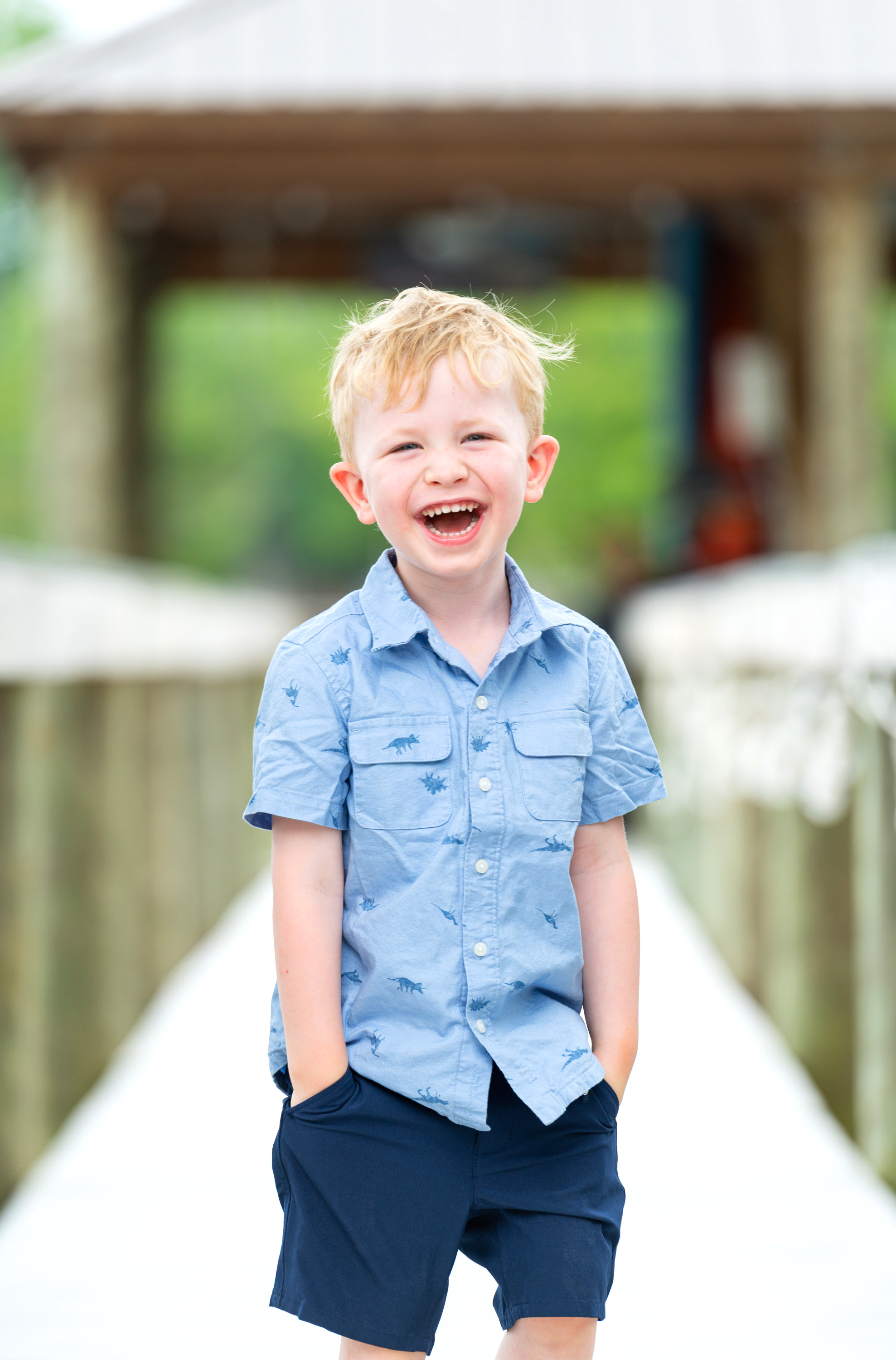 Adorable candid photo of young boy laughing on a dock on Lake Wylie in Belmont, NC. 