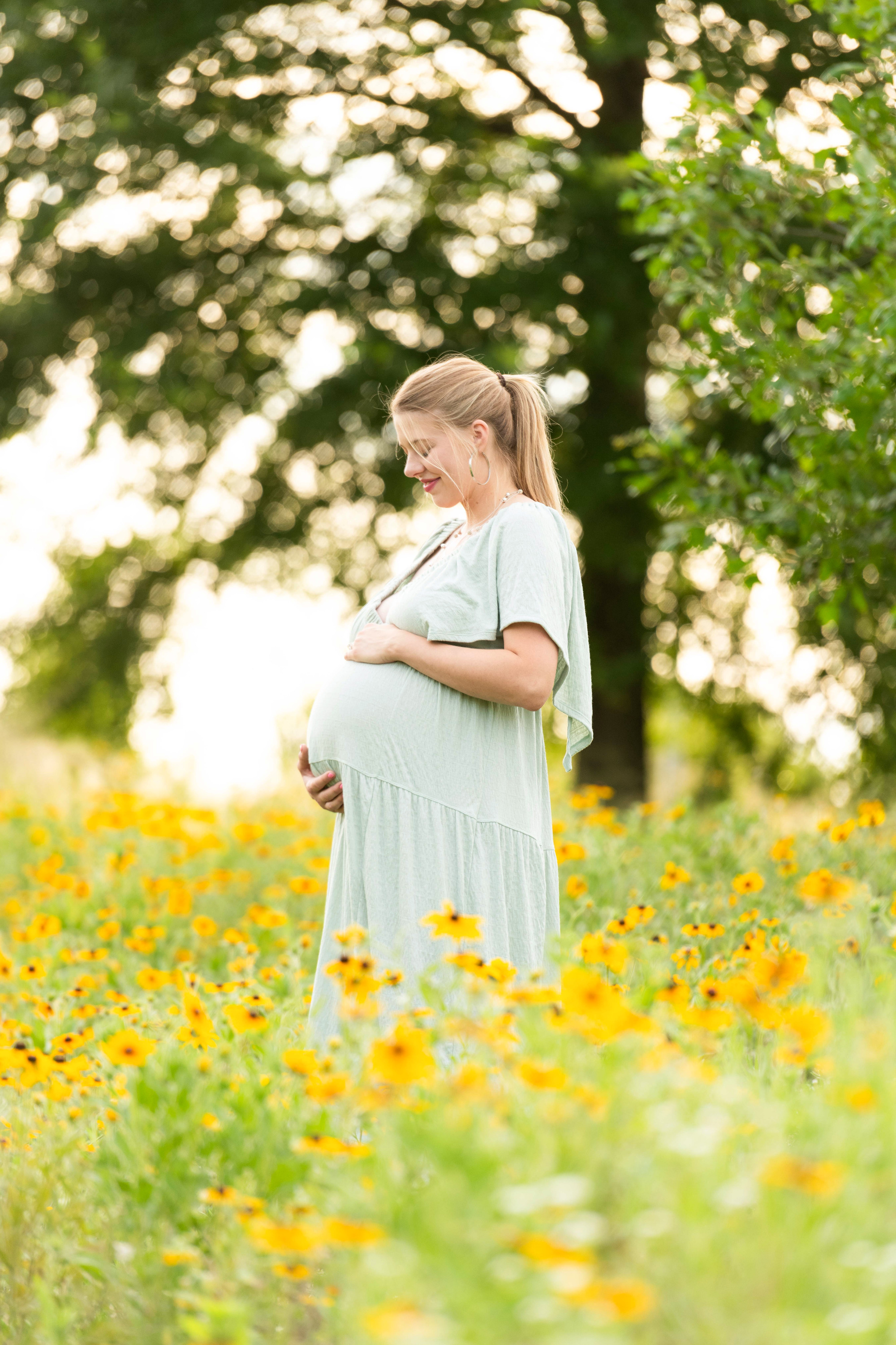 Dreamy spring flower field maternity photos. Charlotte family portrait photographer.