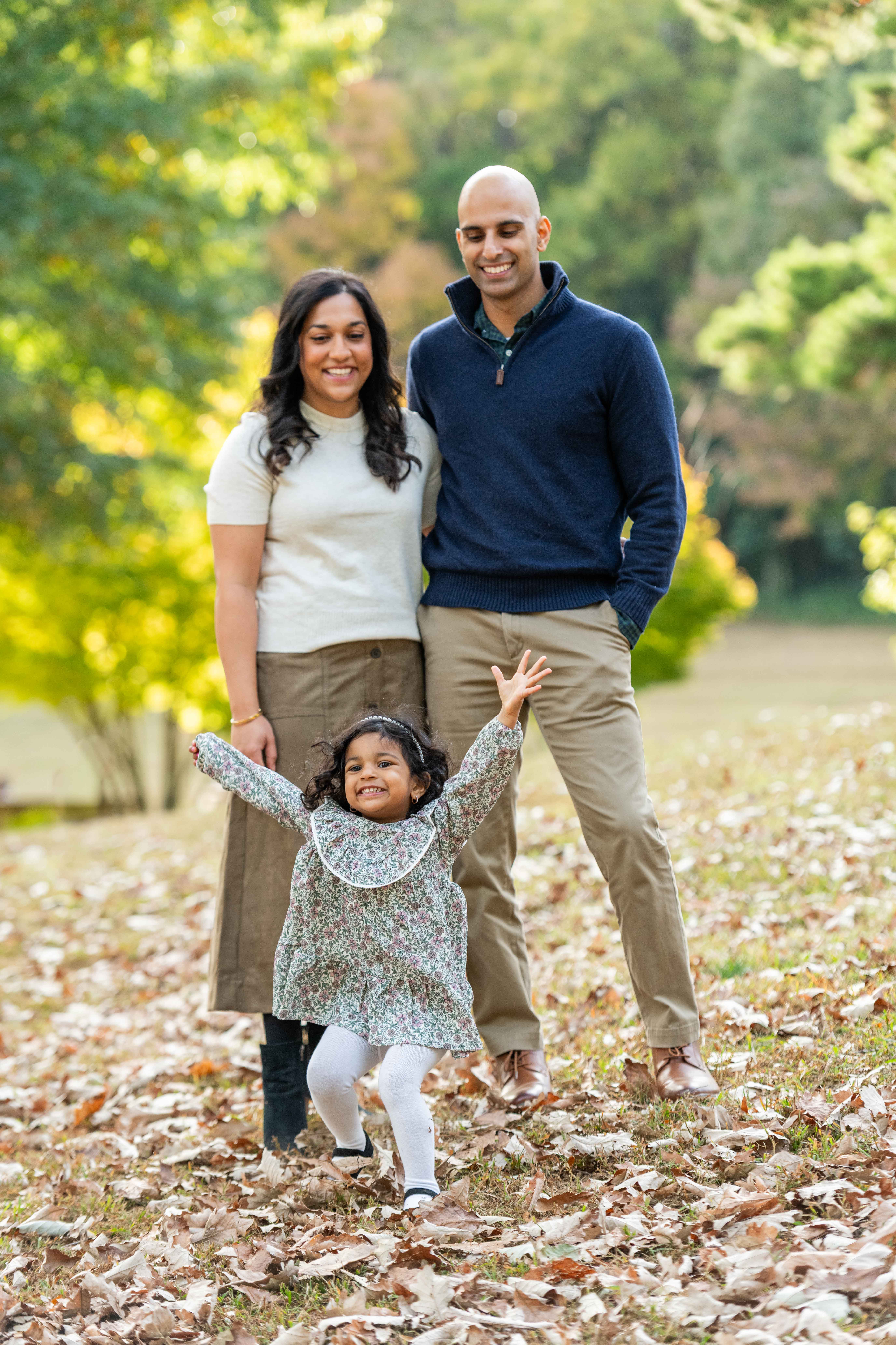Candid photo of family playing in the leaves at Freedom Park in Uptown.  Charlotte family photographers 