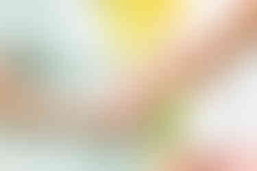 Dreamy flower field maternity photos Charlotte NC.  Couple standing in yellow flower field at North Carolina Museum of Art.
