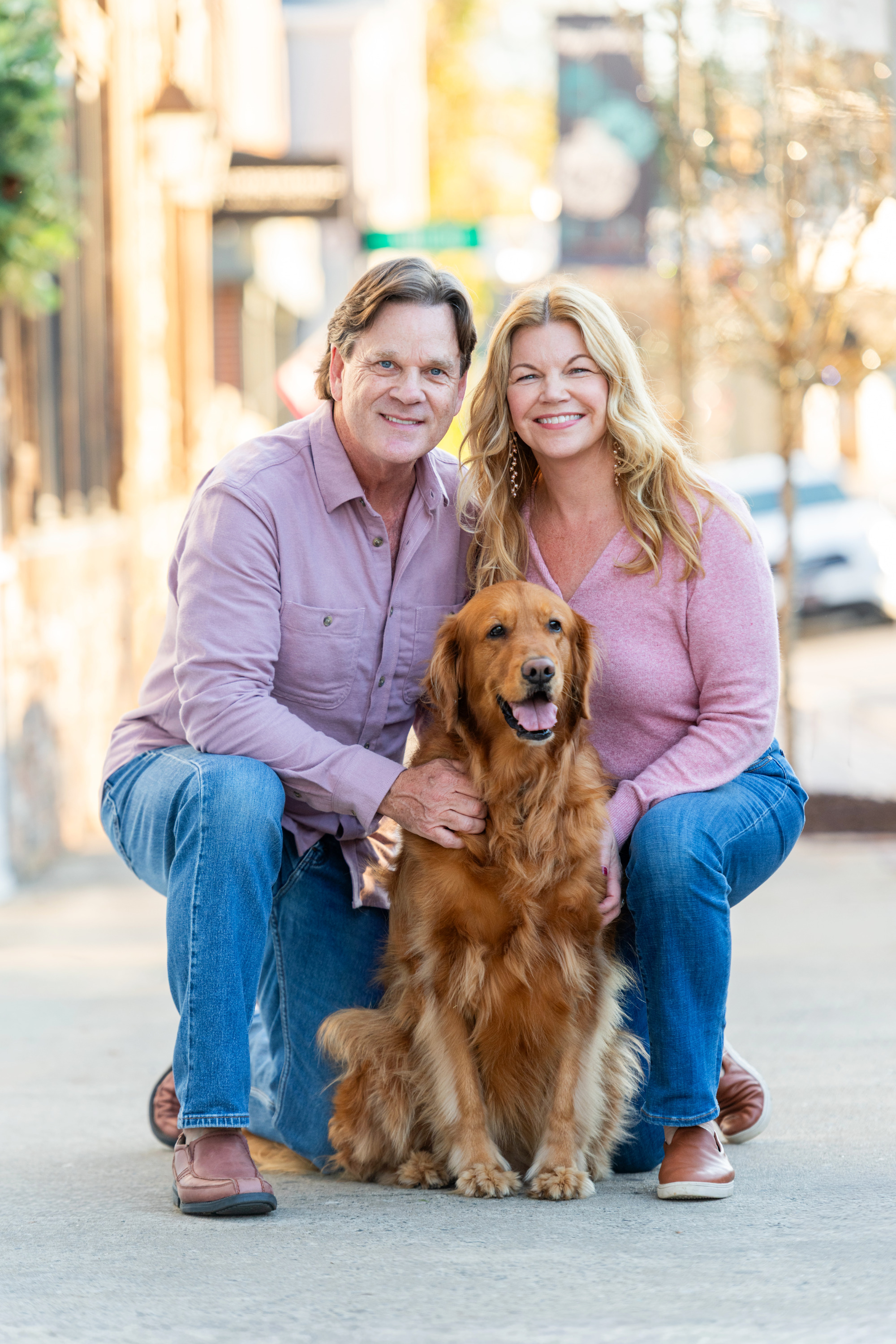 Family portrait of husband, wife and their dog in downtown Belmont, North Carolina. 