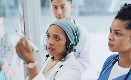 Meeting, healthcare and teamwork with a doctor black woman coaching her team on glass in a