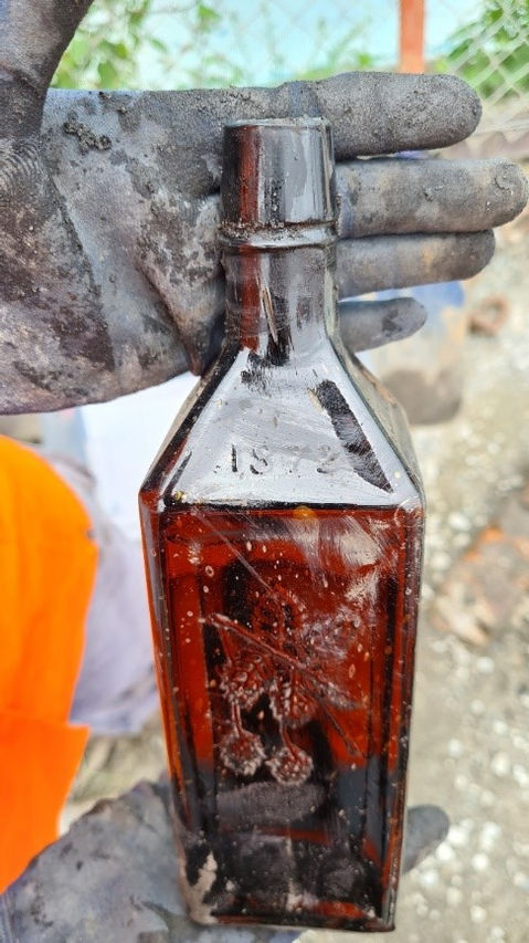 Intact 1872 Hops Bitters bottle, manufactured by John Doyle of Rochester, New York. The bottle was found in the above Locomotive Service Pit.