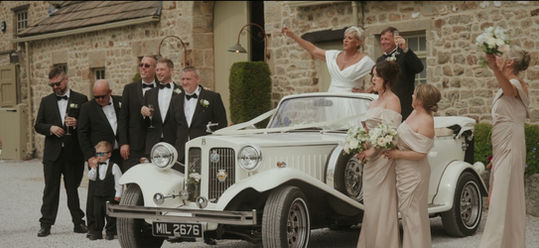 Tithe Barn wedding party on car
