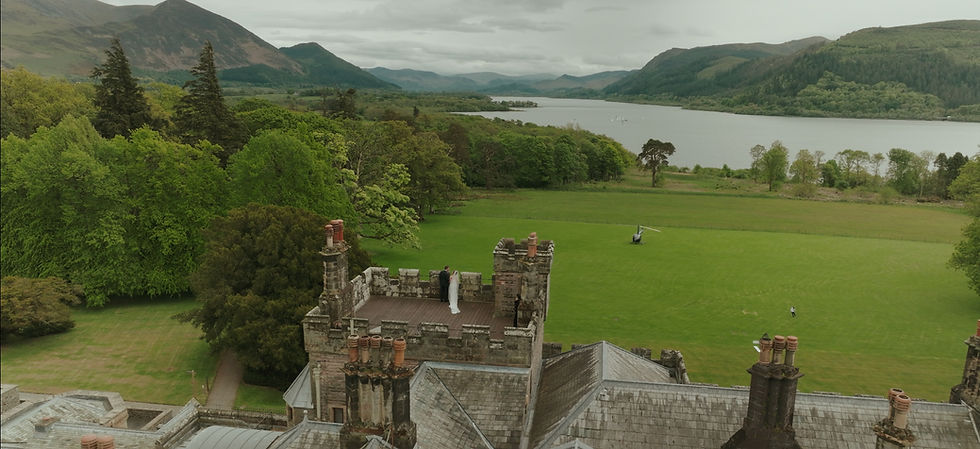 View of Bride and groom on the turret at Armathwaite hall taken with a drone