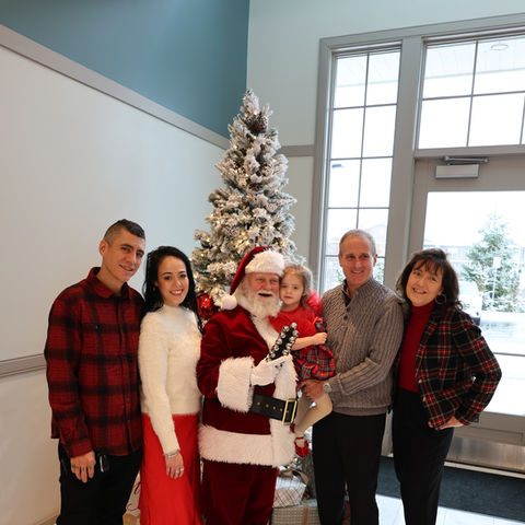 Family posing with Santa at Bedford Event Center Christmas event Bedford, NH