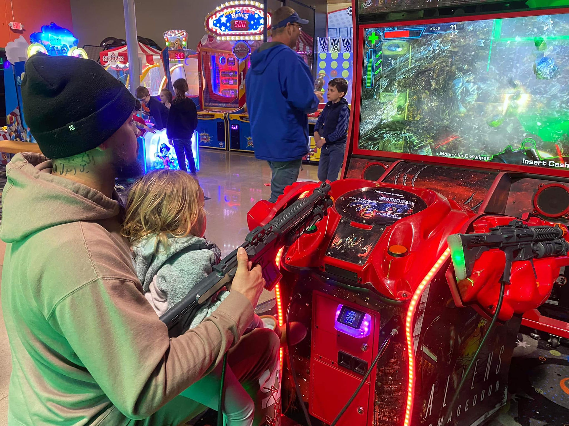dad and kids playing arcade games at the fun lab in blaine mn