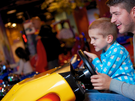 dad and son playing arcade games having fun
