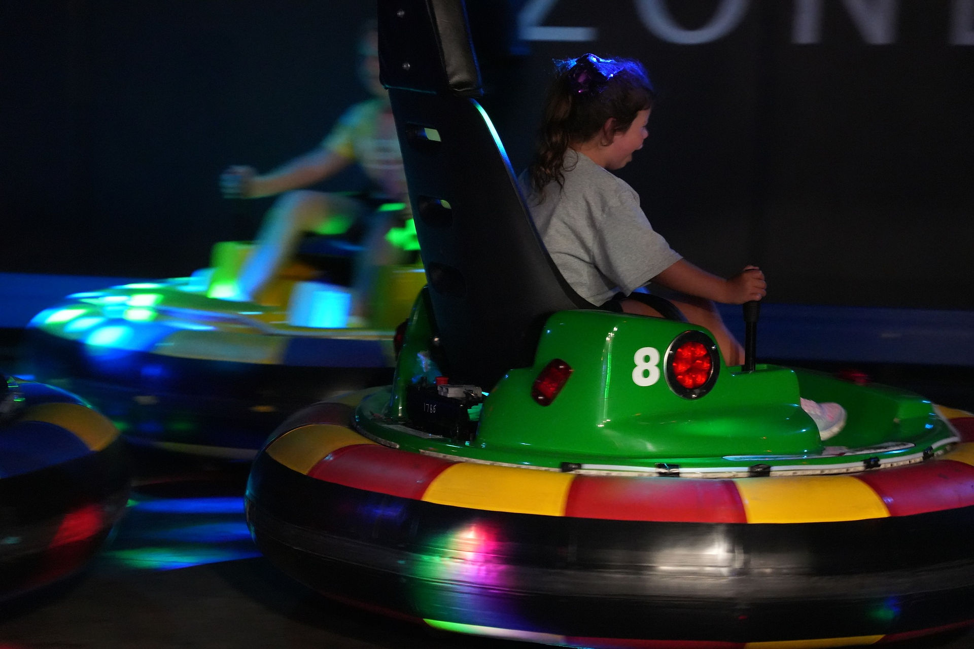 Child riding a brightly lit bumper car at The Fun Lab Center, a top family attraction in Blaine, near Minneapolis, MN