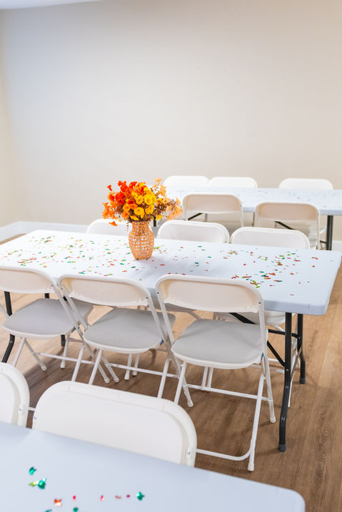 Birthday party table setup with flowers and confetti at Bounce City Idaho Falls.
