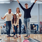 Group of friends celebrating a bowling strike in Norfolk