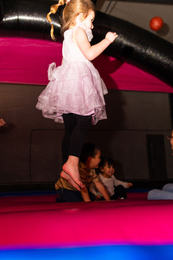 Kids jumping and playing together on inflatable mats at Bounce City.